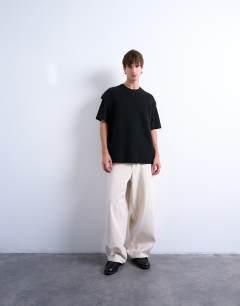 Model wearing Oversized fit knitted crew neck tank in black