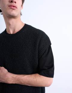Model wearing Oversized fit knitted crew neck tank in black