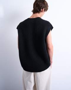 Model wearing Oversized fit knitted crew neck tank in black
