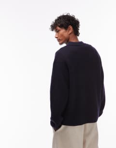 Model wearing Oversized fit knitted polo in navy