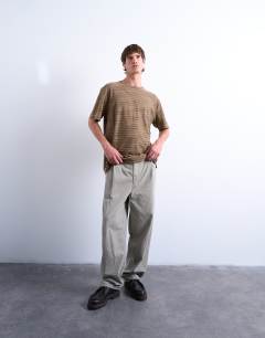 Model wearing Oversized fit knitted stripe t-shirt in brown