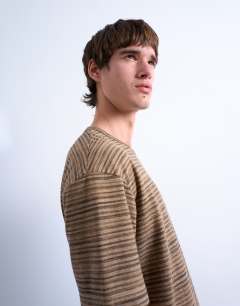 Model wearing Oversized fit knitted stripe t-shirt in brown