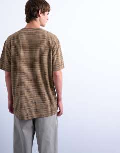 Model wearing Oversized fit knitted stripe t-shirt in brown
