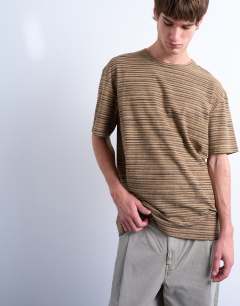 Model wearing Oversized fit knitted stripe t-shirt in brown
