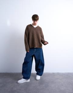 Model wearing Oversized fit knitted v-neck jumper in brown