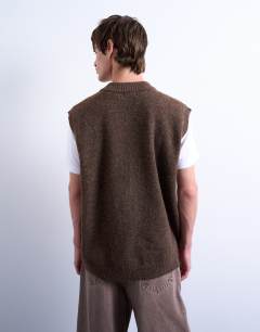 Model wearing Oversized fit knitted v-neck tank in brown