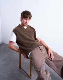 Model wearing Oversized fit knitted v-neck tank in brown