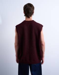 Model wearing Oversized fit knitted v-neck tank in burgundy
