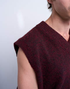 Model wearing Oversized fit knitted v-neck tank in burgundy