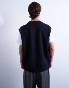 Model wearing Oversized fit knitted v-neck tank in navy