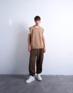 Model wearing Oversized fit knitted v-neck tank in stone