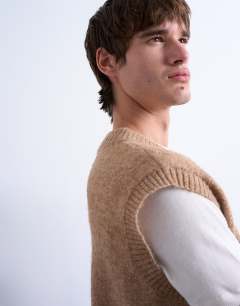 Model wearing Oversized fit knitted v-neck tank in stone