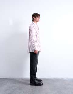 Model wearing Oversized fit long sleeve stripe shirt in burgundy