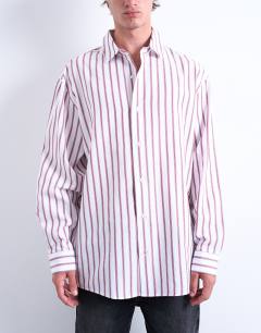 Model wearing Oversized fit long sleeve stripe shirt in burgundy