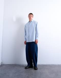 Model wearing Oversized fit long sleeve stripe shirt in light blue & yellow