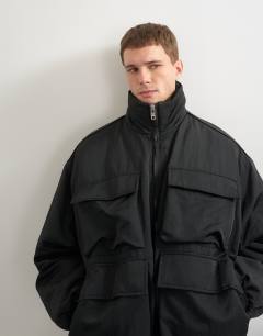 Model wearing Oversized fit nylon funnel neck bomber jacket in black
