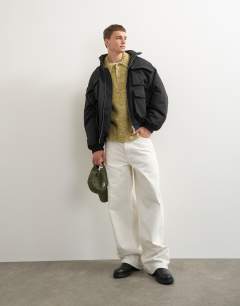 Model wearing Oversized fit nylon funnel neck bomber jacket in black