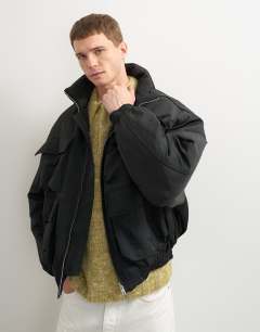 Model wearing Oversized fit nylon funnel neck bomber jacket in black
