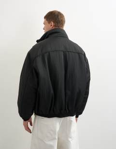 Model wearing Oversized fit nylon funnel neck bomber jacket in black