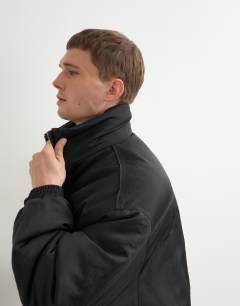 Model wearing Oversized fit nylon funnel neck bomber jacket in black
