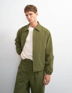 Model wearing Oversized fit nylon ripstop harrington jacket in green