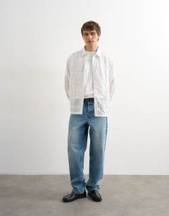 Model wearing Oversized fit patchwork shirt in white