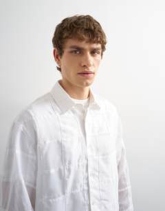 Model wearing Oversized fit patchwork shirt in white