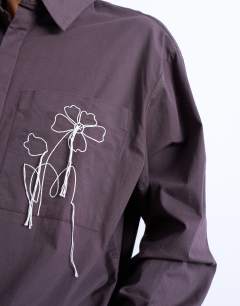 Model wearing Oversized fit poplin shirt with floral embroidery in brown
