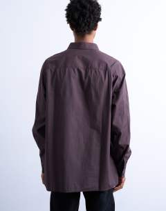 Model wearing Oversized fit poplin shirt with floral embroidery in brown
