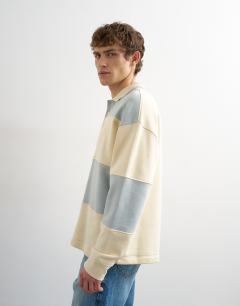 Model wearing Oversized fit rugby polo sweatshirt in blue and cream