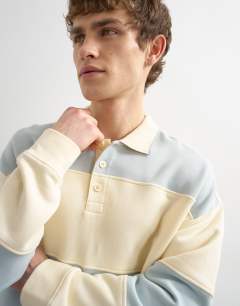 Model wearing Oversized fit rugby polo sweatshirt in blue and cream