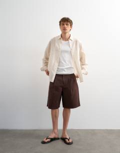 Model wearing Oversized fit sheer stripe shirt in ecru