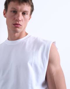 Model wearing Oversized fit sleeveless t-shirt in white