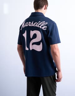 Model wearing Oversized fit sports polo shirt with Marseille back embroidery in navy