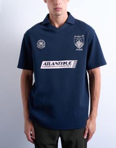 Model wearing Oversized fit sports polo shirt with Marseille back embroidery in navy