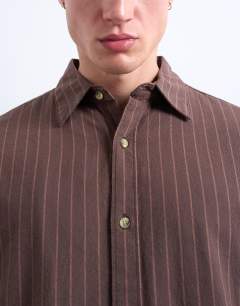 Model wearing Oversized fit stripe oxford shirt in washed brown