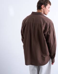 Model wearing Oversized fit stripe oxford shirt in washed brown