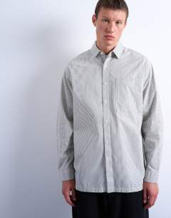 Model wearing Oversized fit stripe shirt in black & ecru