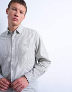 Model wearing Oversized fit stripe shirt in black & ecru