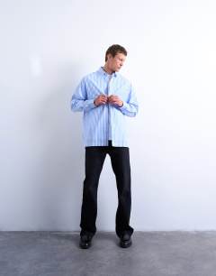 Model wearing Oversized fit stripe shirt in blue