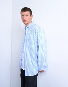Model wearing Oversized fit stripe shirt in blue
