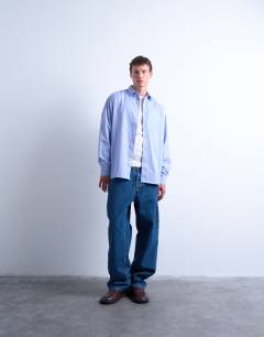 Model wearing Oversized fit stripe shirt in blue
