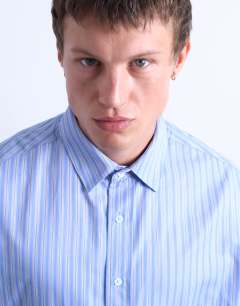 Model wearing Oversized fit stripe shirt in blue