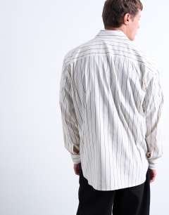 Model wearing Oversized fit stripe shirt in ecru