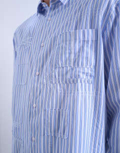 Model wearing Oversized fit stripe shirt with all over distressing in blue
