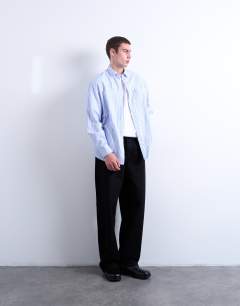 Model wearing Oversized fit stripe shirt with all over distressing in blue