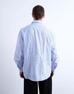 Model wearing Oversized fit stripe shirt with all over distressing in blue