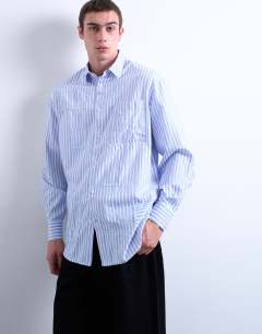 Model wearing Oversized fit stripe shirt with all over distressing in blue