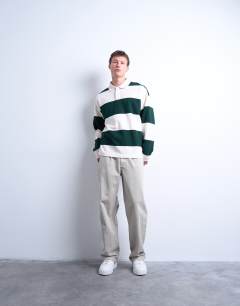 Model wearing Oversized fit striped rugby polo in dark green