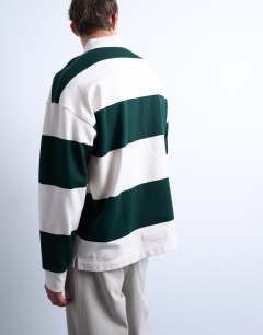 Model wearing Oversized fit striped rugby polo in dark green